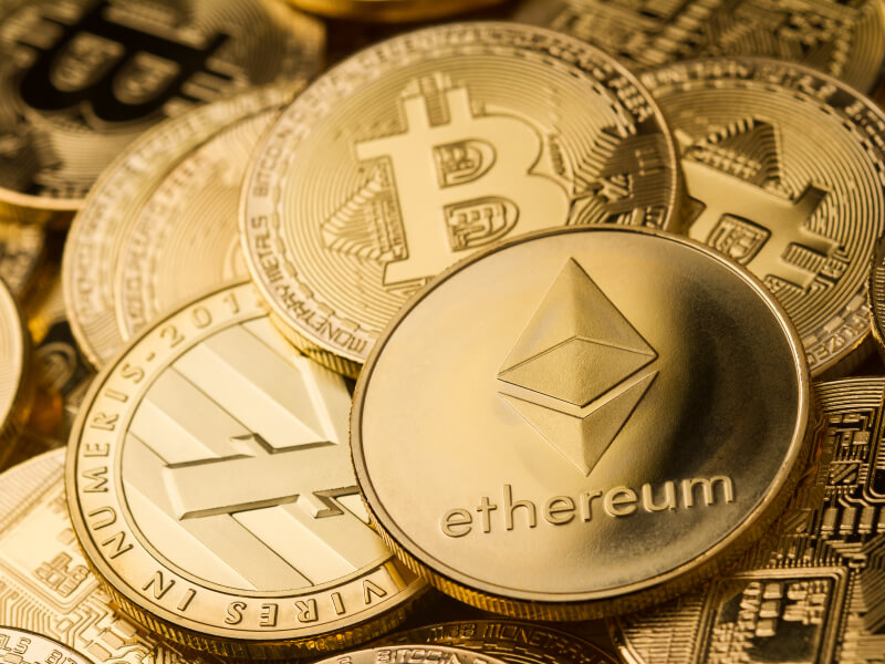 background filled with different physical cryptocurrencies
