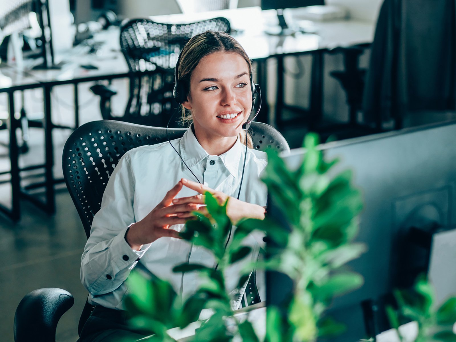 women in office with headphone