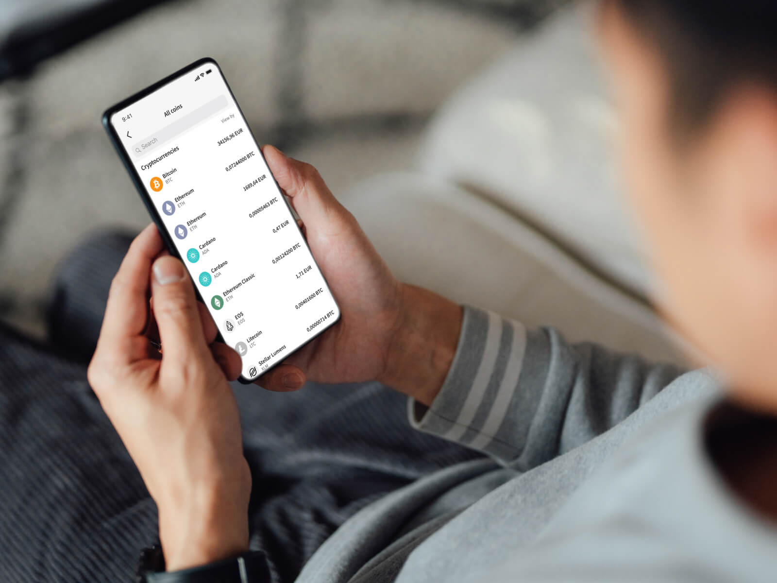 Man looking at all the available cryptocurrencies on Skrill mobile