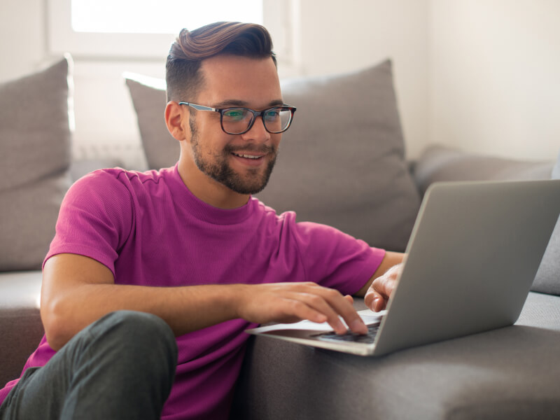 man looking on his laptop