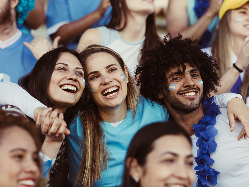 supporters at match smiling and cheering