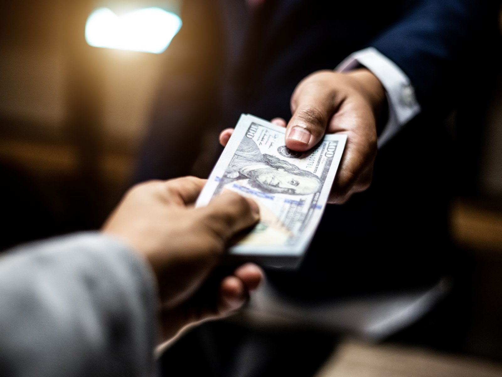 two people handing over money