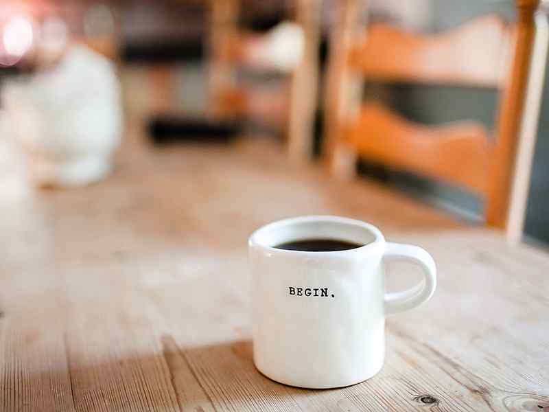 morning coffee with a "Begin" inscription on it