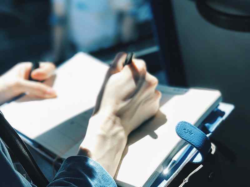 person writing in a notebook