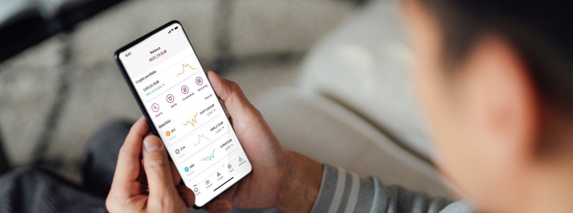 man looking at phone showing crypto chart