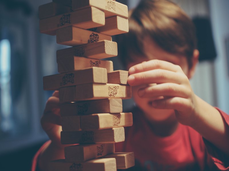 kid playing Jenga