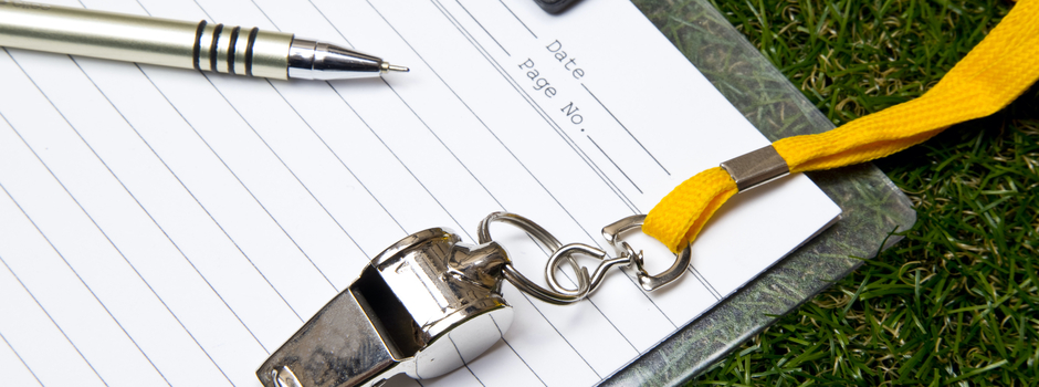 a pen and a whistle on blank paper