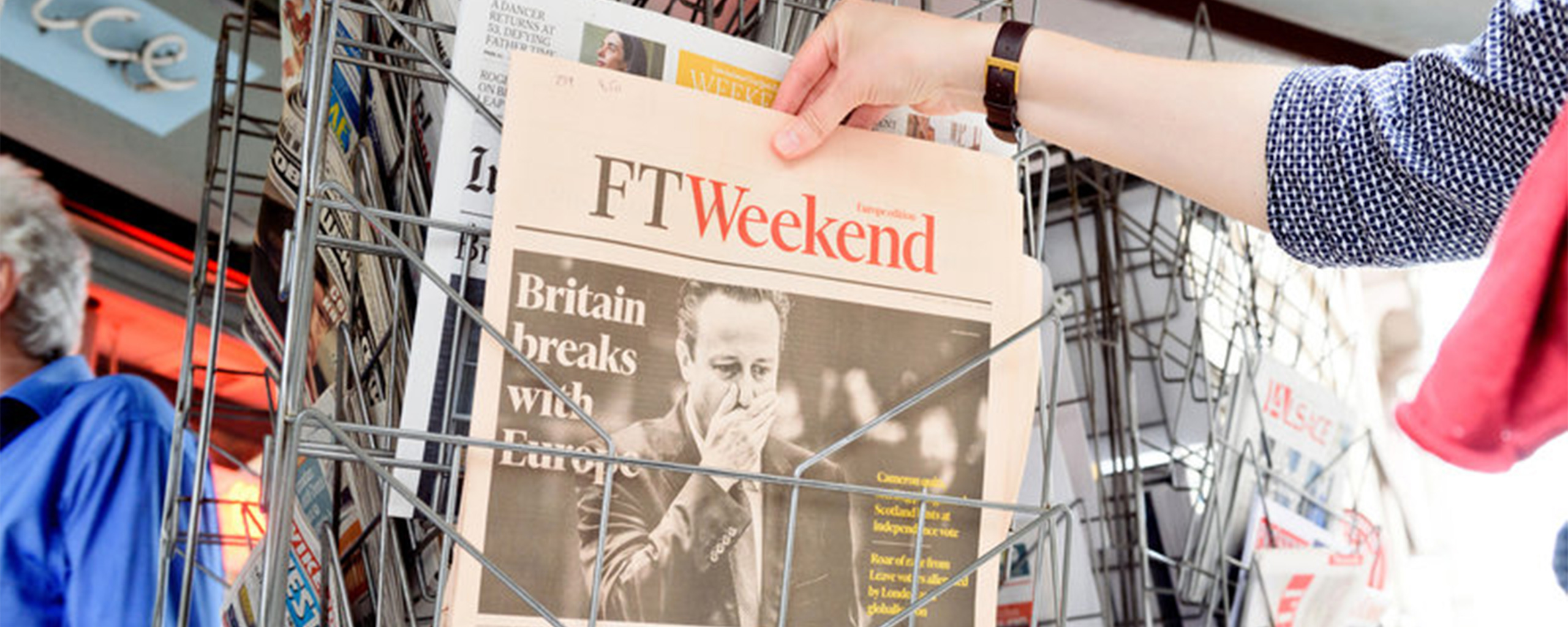 woman buying FTWeekend newspaper