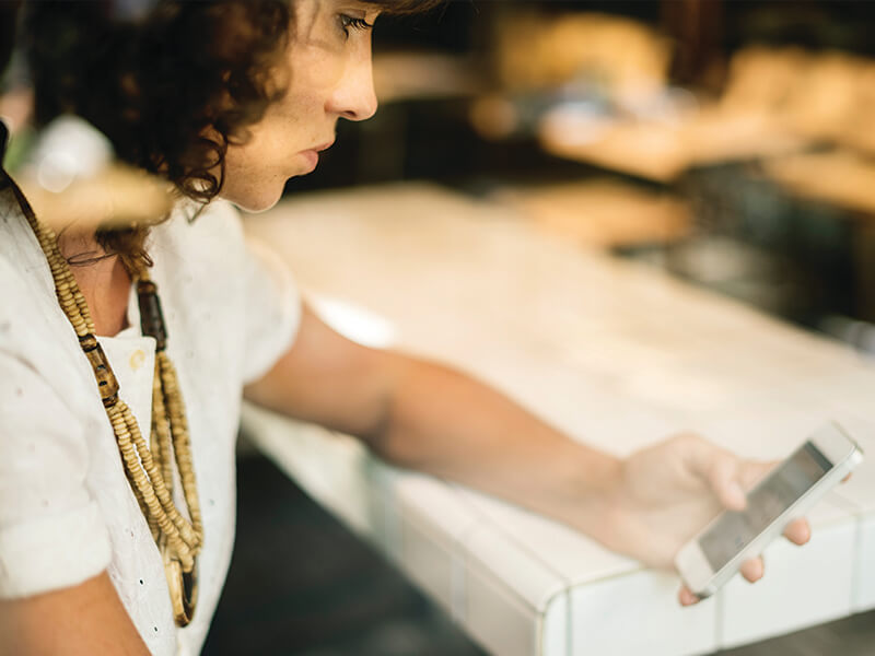 woman investing on her mobile