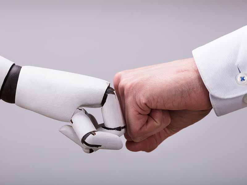 machine and human fist bump