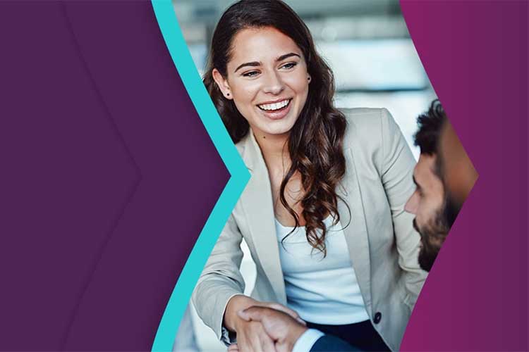 Skrill's merchant partners; smiling business woman shaking hands with a business partner