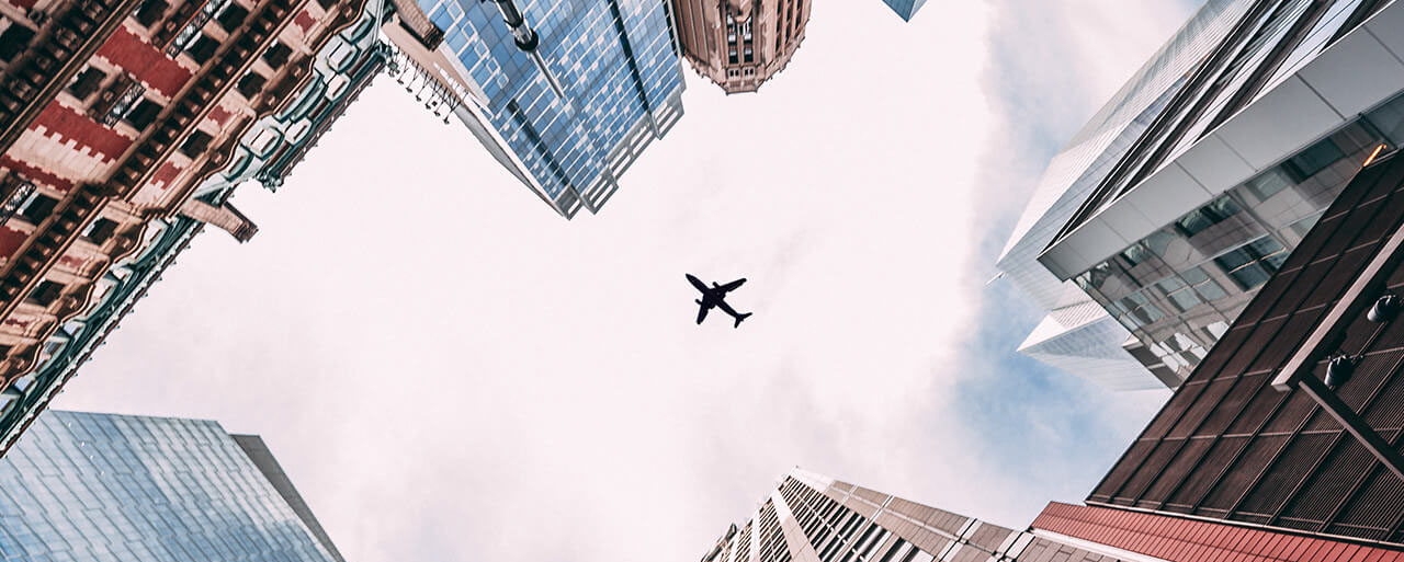 Plane between buildings