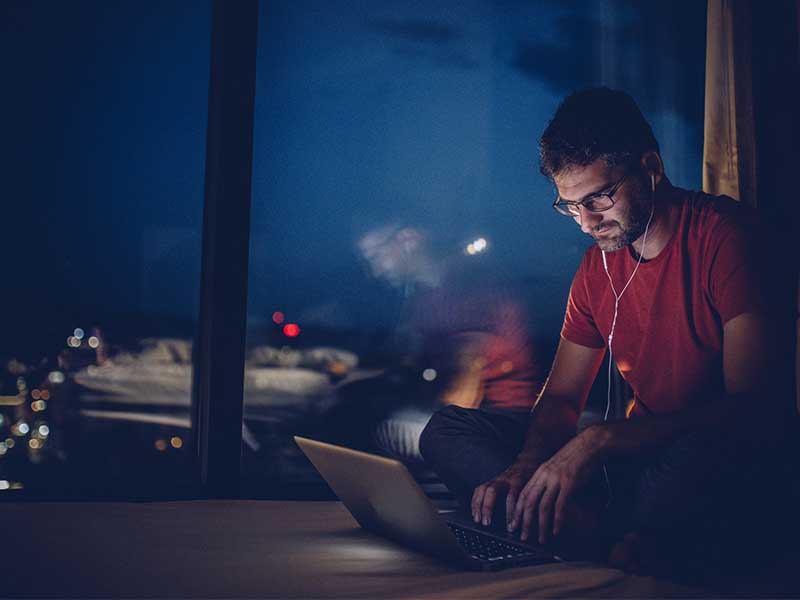 man playing poker at night at home