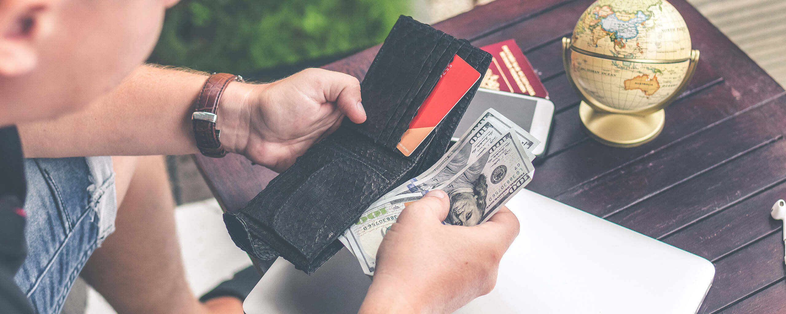 man taking out dollars from his wallet