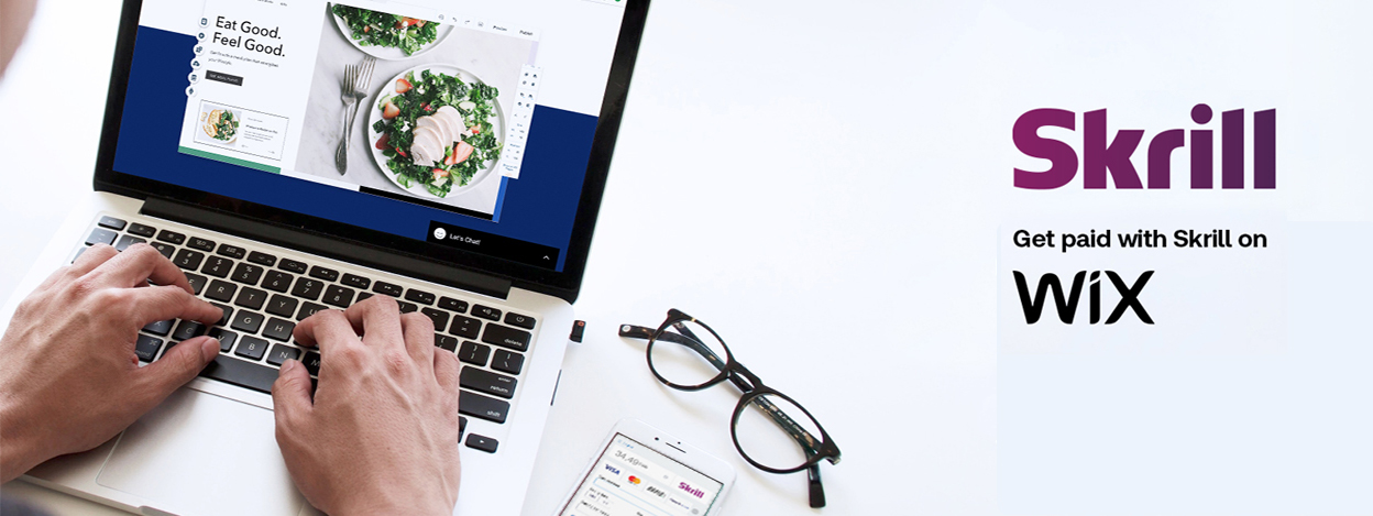 laptop with web store opened on the screen, phone with Skrill payment gateway, Skrill and Wix work together