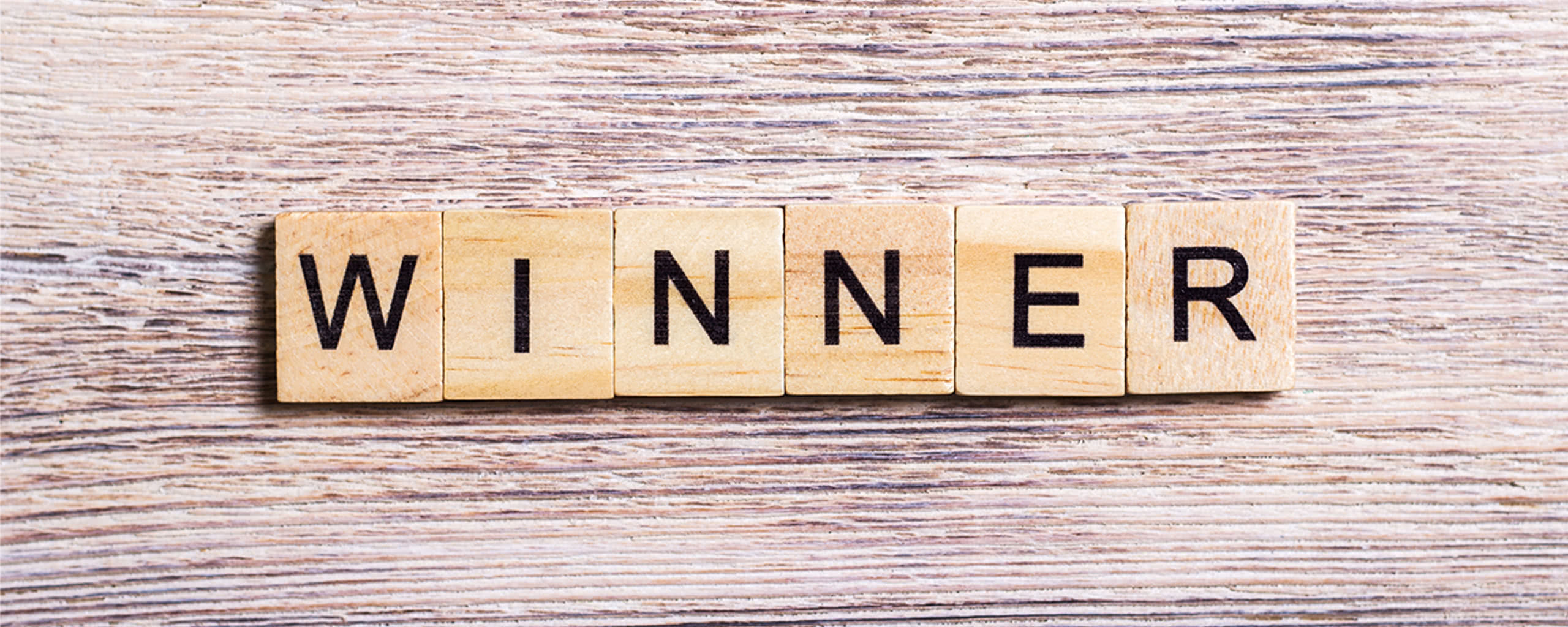wooden letters forming the word "winner"