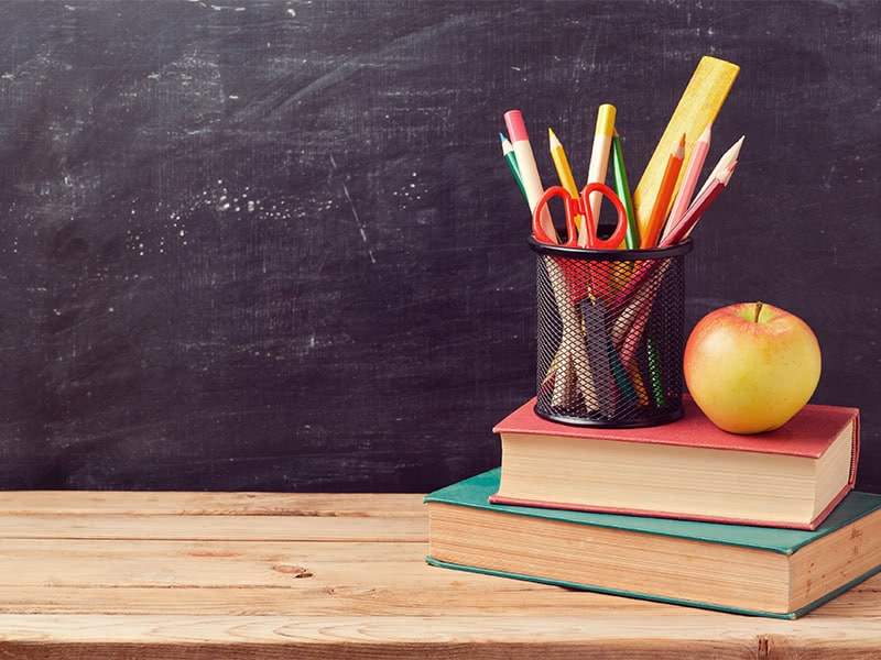 blackboard with books and pencils in front