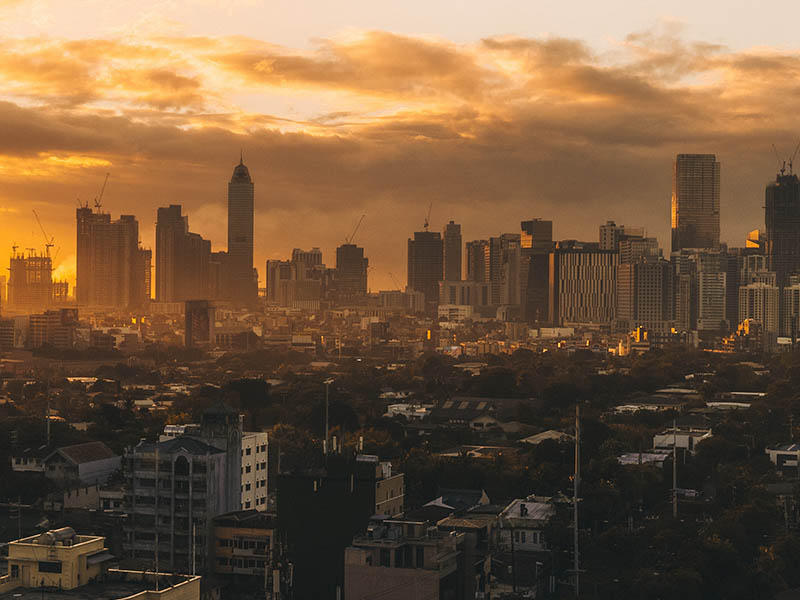 Skyline of a city at sunset with an orange hue