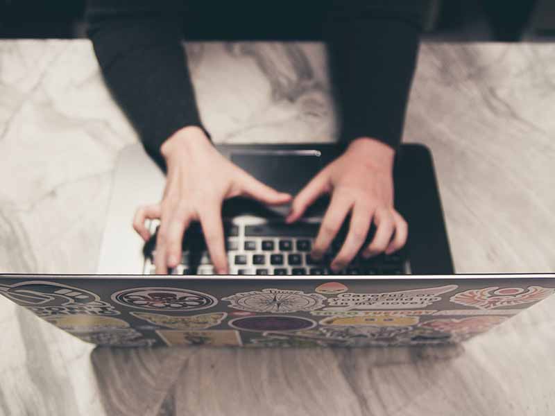 typing on laptop