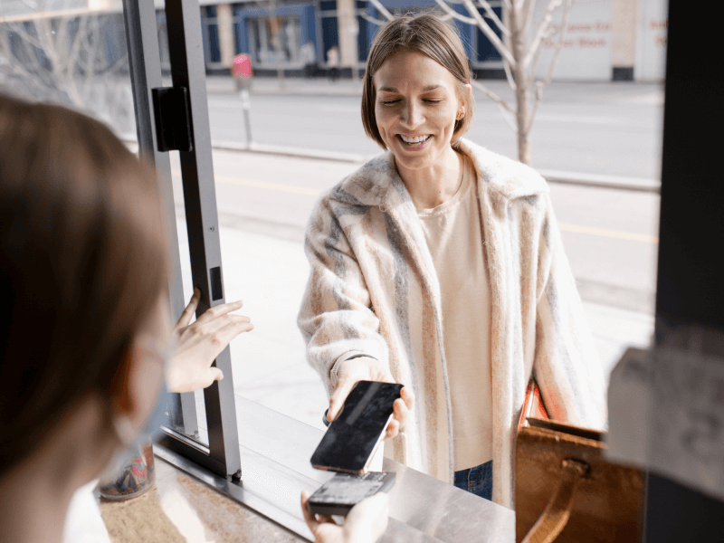 Woman paying with phone