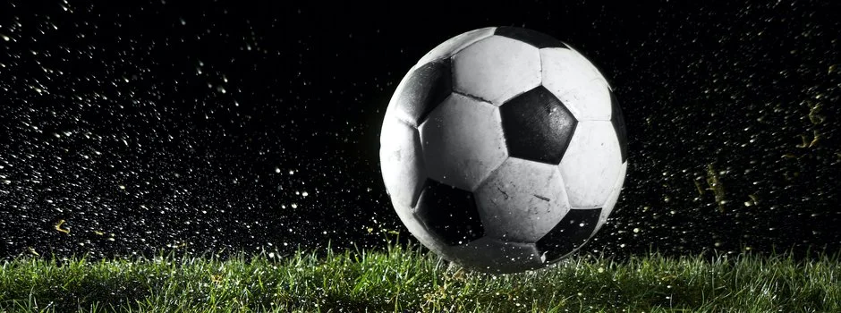Soccer ball in motion over grass