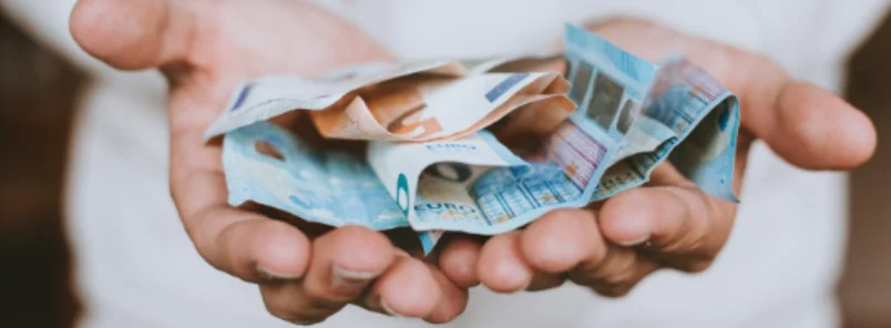 hands holding banknotes