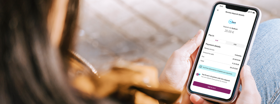 woman holding phone with Skrill App open ready for payment